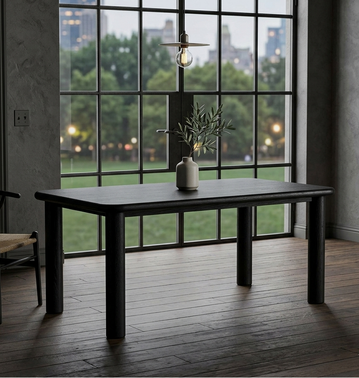 Dark wooden dining table in a room with large windows and cityscape view