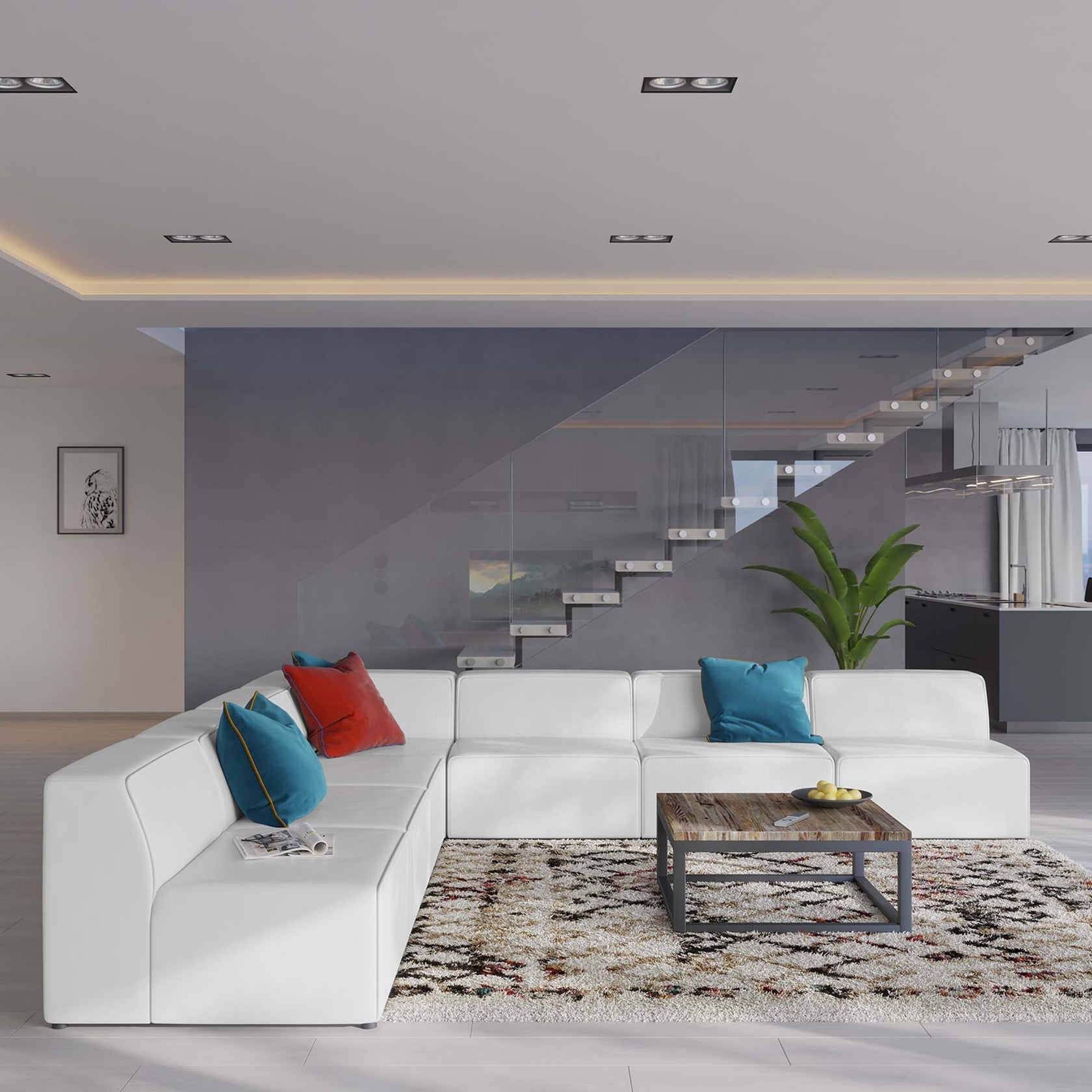 Modern living room with a white sectional sofa, colorful pillows, and a coffee table.