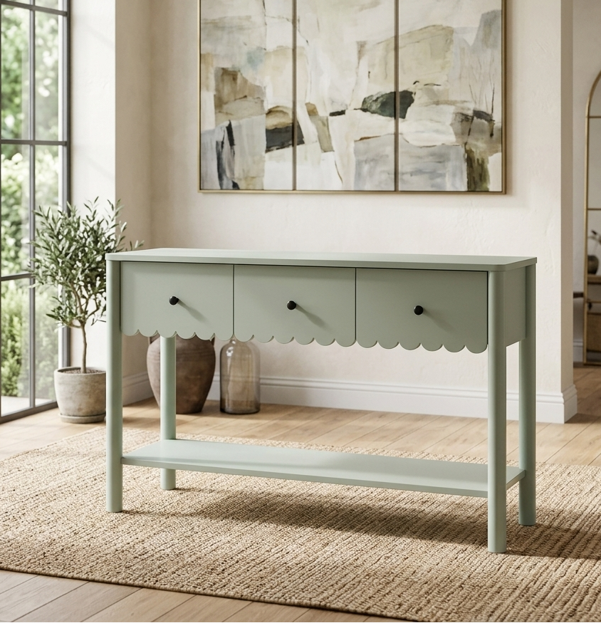 Light green console table in a room with abstract art on the wall and large windows.