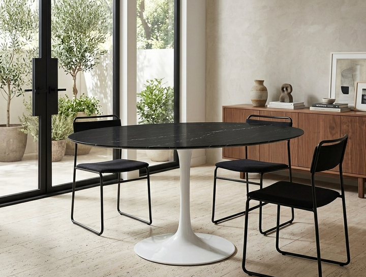 Modern dining room with a black marble table and black chairs in a bright room.