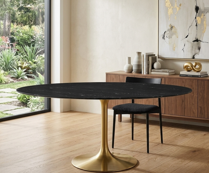 Modern dining table with black marble top and gold base in a stylish room.