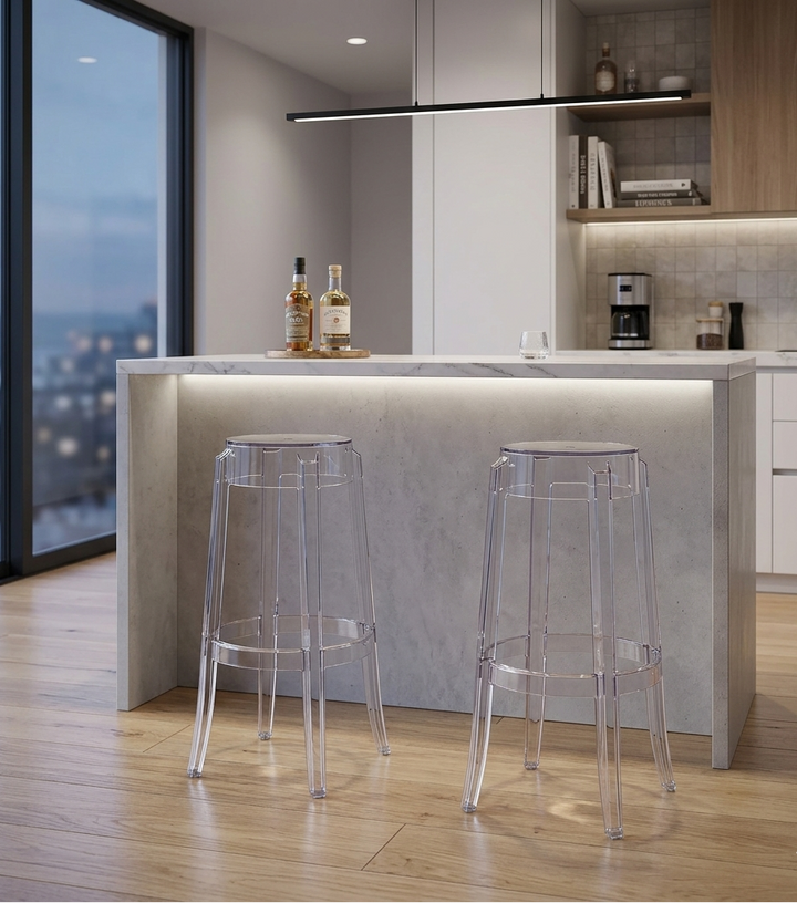Modern kitchen with a bar area featuring two clear stools.
